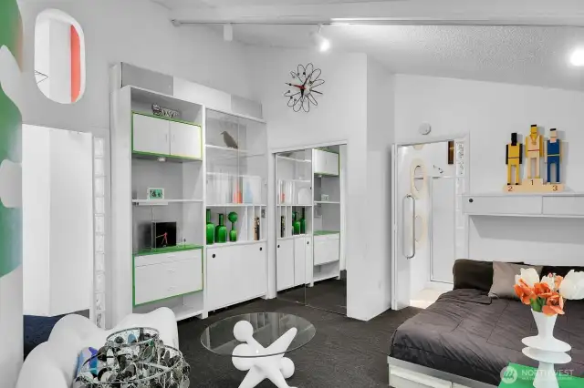 Primary bedroom suite on the main floor with shower and built ins for storage and decorations.