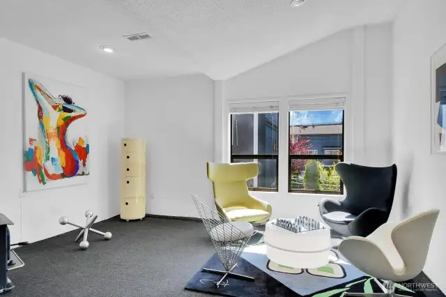 ADU: Lower level bonus room with South facing windows and fireplace.