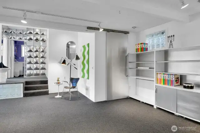 Lower level bonus room with built in shelves & utility room.