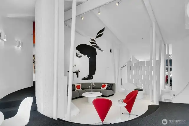 Looking for a house that stands out that's far from a cookie cutter, here it is. There is a large window behind the architectural wall divider. The pillars are non-structural and solely for aesthetic design.