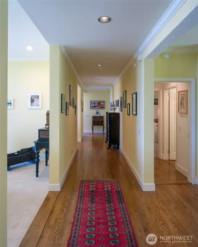 The gallery hall ends at the kitchen/family room with living room on the left and main floor bedroom & full bath on the right.