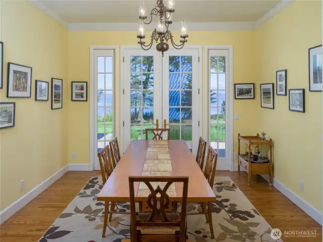 The dining room has French doors to the deck and just out of sight are built-in cabinets.