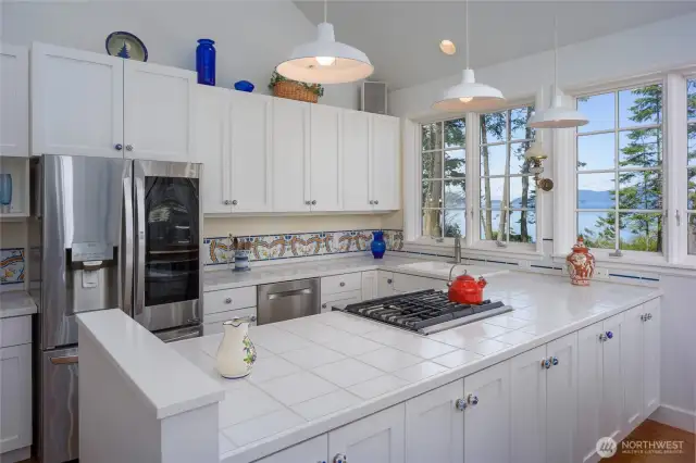 The kitchen has SS appliances, tile counters and walk-in pantry plus great water views.