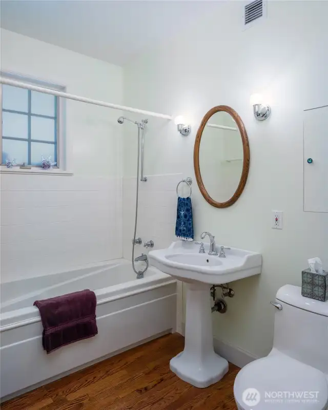 Main floor full bathroom is adjacent to the bedroom and right off the entry hall.