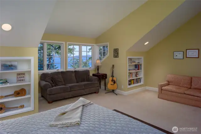Another view of the primary bedroom with built-in bookcases and room for 2 sofas if you want.