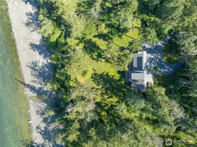 Looking directly down at the house , yard and beach.
