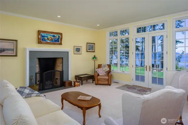 Generous living room has Rumford fireplace and French doors to the large deck.