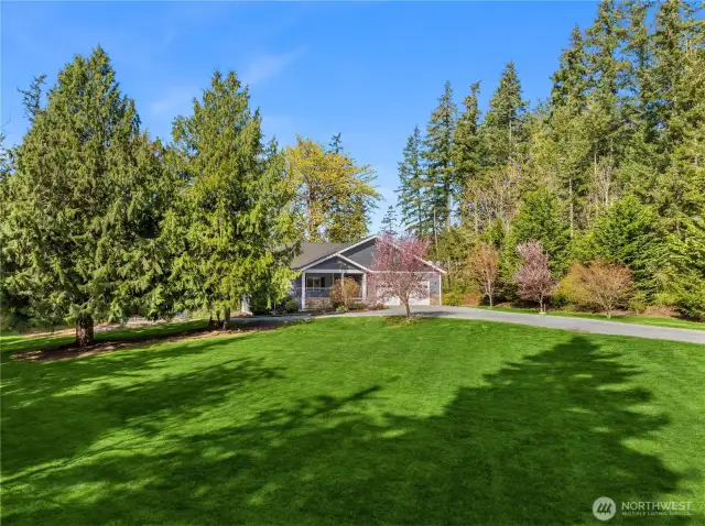 Over 2 acres of level lush lawn and tall trees.