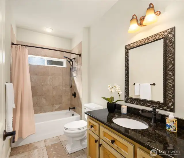 Guests have a full bath will tiled floors.
