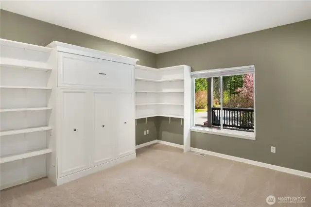 The 3rd bedroom offers a Murphy bed and built in shelving.