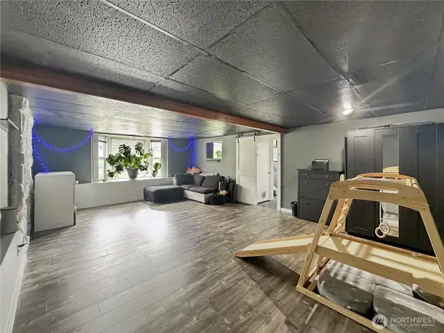 The same big Bonus room downstairs with fireplace.