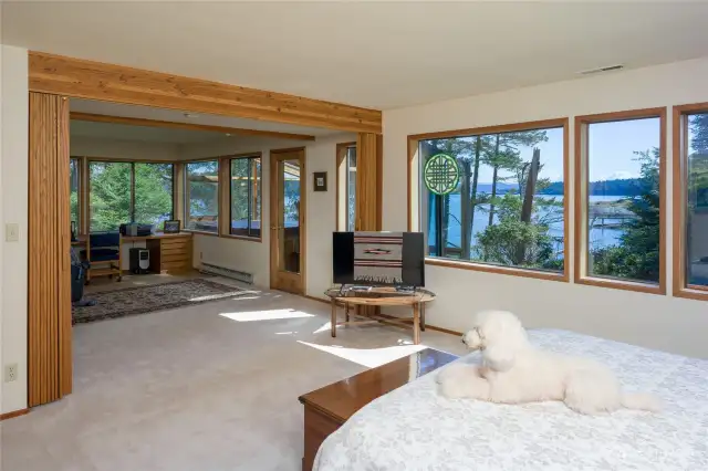 Primary bedroom can be separated from the office with acordian folding doors. Glass door goes to hot tub room.