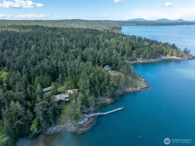 Birdseye view looking north shows house, guesthouse, shop/garage and dock.