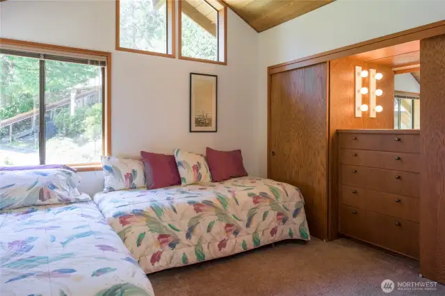 Smaller bedroom.  Both bedrooms have built-in dresser with hanging closet space on each side.