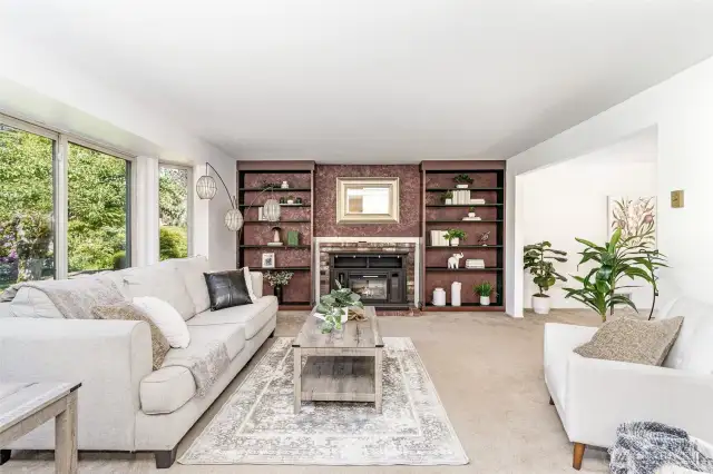 Living room has bay window, built-in bookcases and fireplace