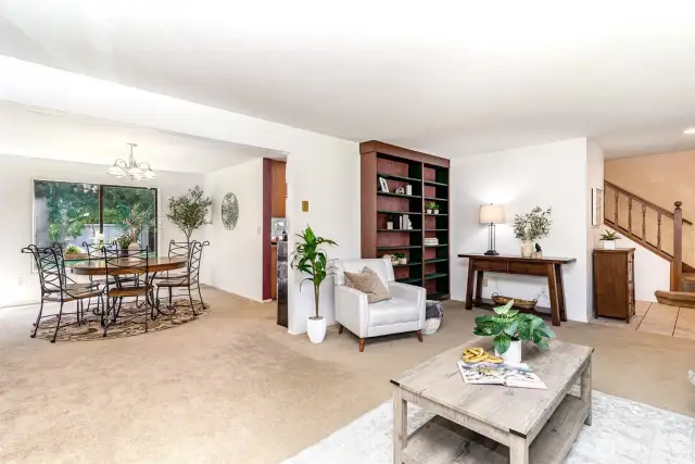 Living room is open to sunny dining room
