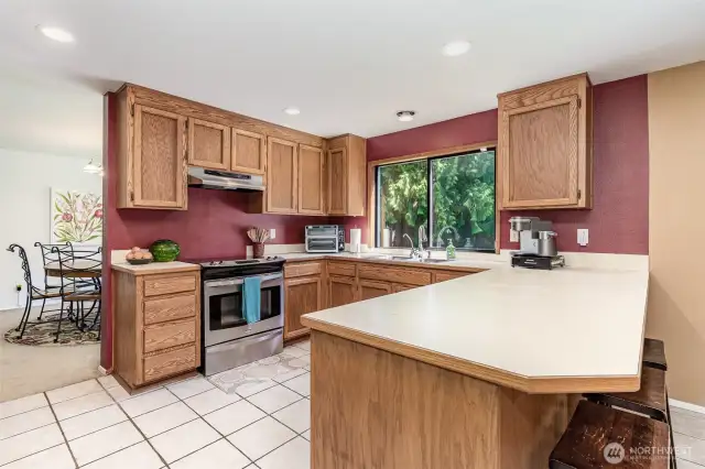 Kitchen with tile floor has ample counters and storage space