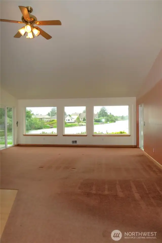 ENTERING THE HOME THROUGH THE FRONT DOOR IMMEDIATELY YOU LOOK THROUGH THE SPECTACULAR WALL OF WINDOWS TO THE CANAL!
