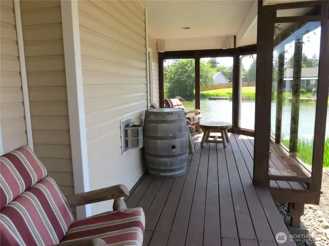 THROUGH THE DINING ROOM SLIDER, ENJOY YOUR FAVORITE BEVERAGE BEHIND THE DECK ENCLOSURE DURING INCLIMATE WEATHER!
