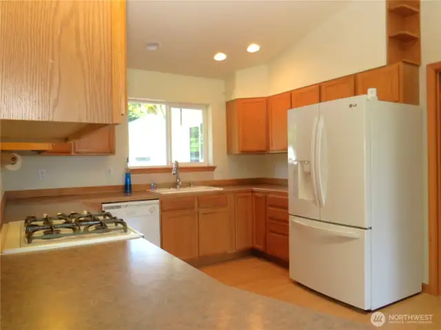 KITCHEN BOASTS PROPANE STOVE, FRENCH DOOR REFRIGERATOR RECESSED LIGHTING PLUS OTHER AMENITIES!