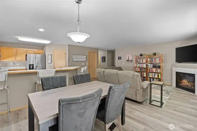 The adjacent dining area seamlessly flows into the living room, making it ideal for hosting dinner parties or enjoying weeknight meals.