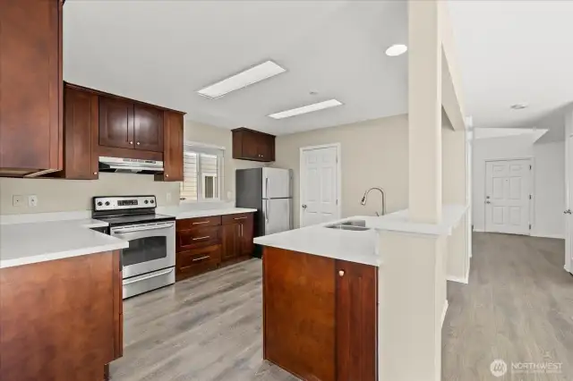 Kitchen features stainless steel appliances, quartz countertop.