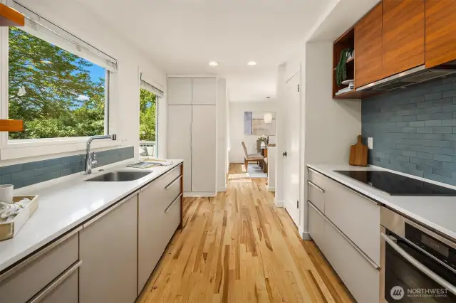 Kitchen with ample counter & storage space, leading into dining area.