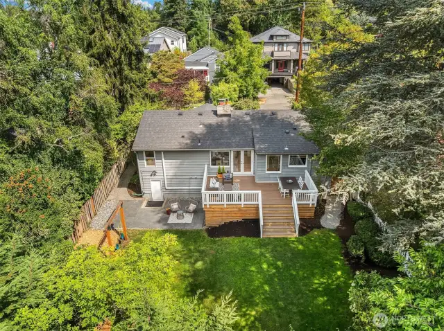 Aerial view of backyard showcasing deck & private backyard space.