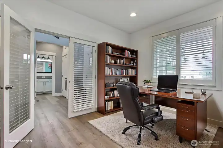 Main level office with French doors located at the front of the house