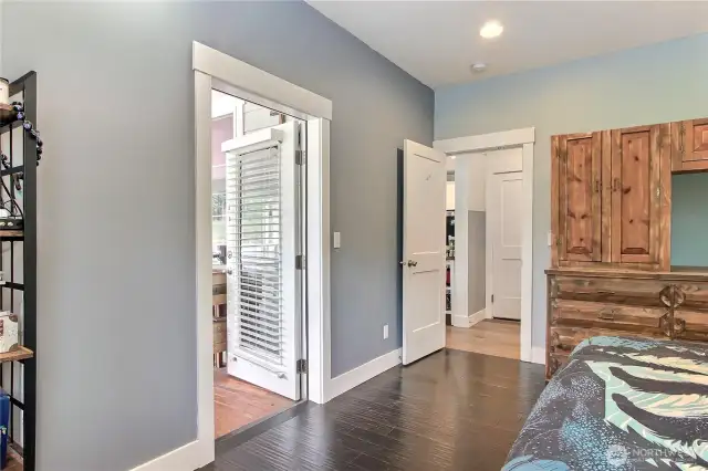private primary bedroom with door leading to the covered porch