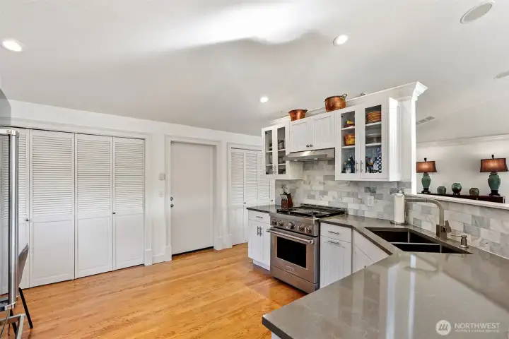 Kitchen storage along the back wall. Unseen is the side deck with a Gas Pizza Oven, BBQ and Beverage Fridge.