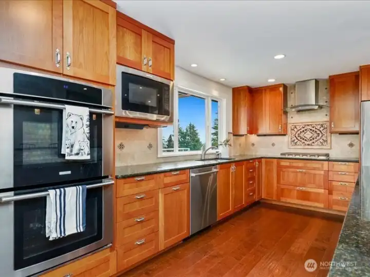 Remarkable chef's kitchen with double ovens, gas cook top, granite counters and Cherry cabinets.