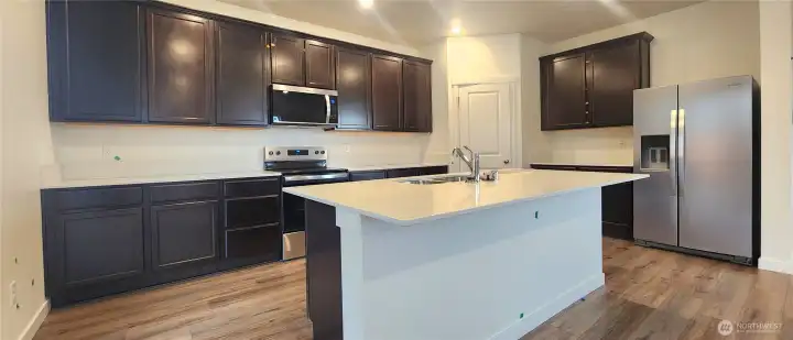 Quartz countertops throughout kitchen and bathrooms.