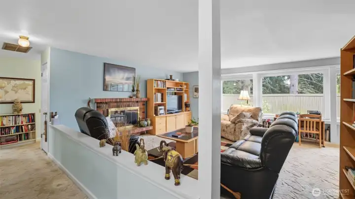 Half wall separates the hallway from the living room