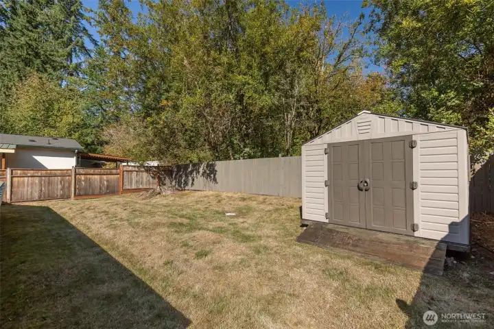 Fully fenced rear yard with garden shed.