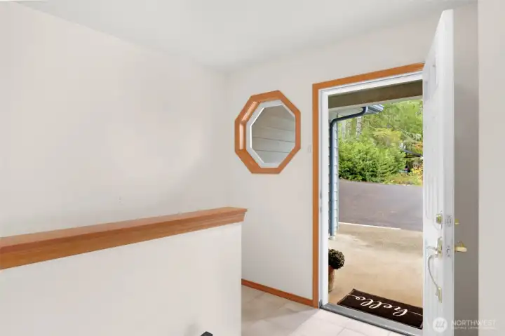 The foyer of this lakefront gem is a large space which opens to the main floor or provides access to the basement area.