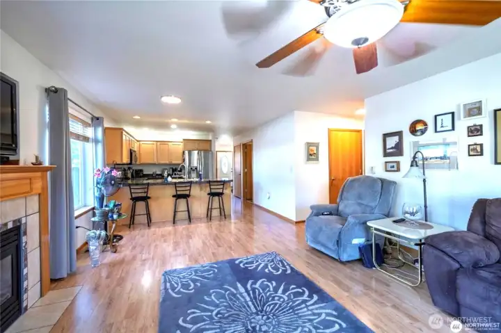 Open living, dining and kitchen areas.