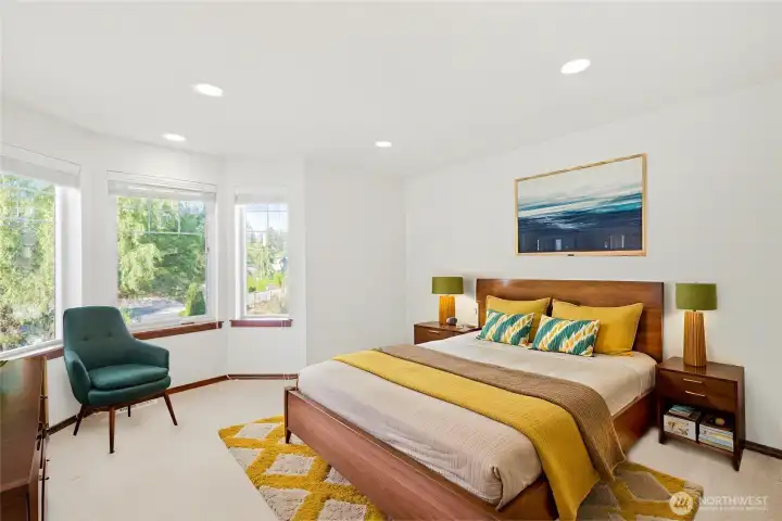 Virtually staged upstairs guest bedroom with traditional architectural details and recessed lighting.