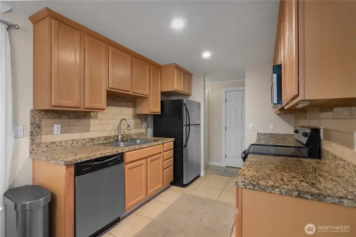 Thoughtfully updated kitchen that features granite countertops and lots of cabinets.