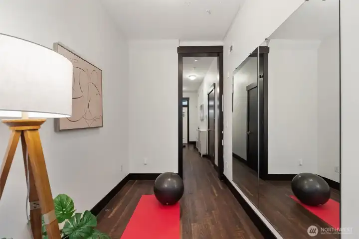 Entry-level flex space with mirrored closet doors—ideal for home office, fitness room, or guest suite.