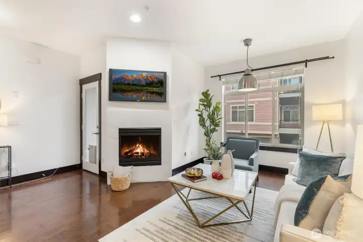 Open living area showcasing hardwood floors and seamless connection to dining space.