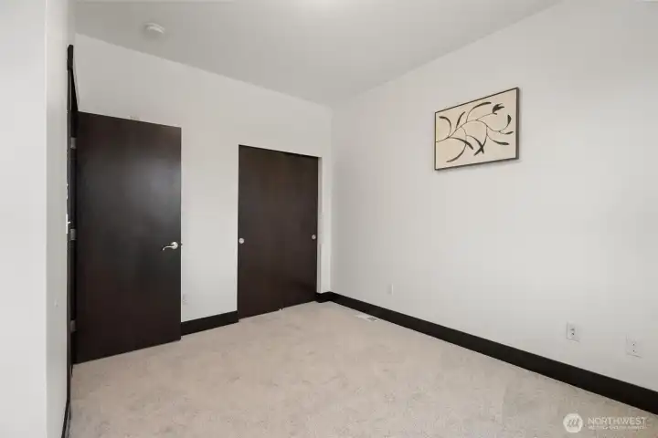Alternate view of secondary bedroom highlighting closet access.