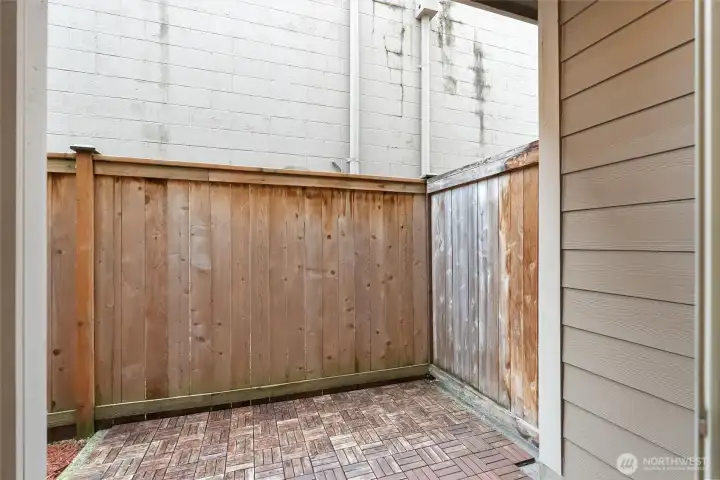 Private fenced patio space ideal for outdoor dining or relaxation.