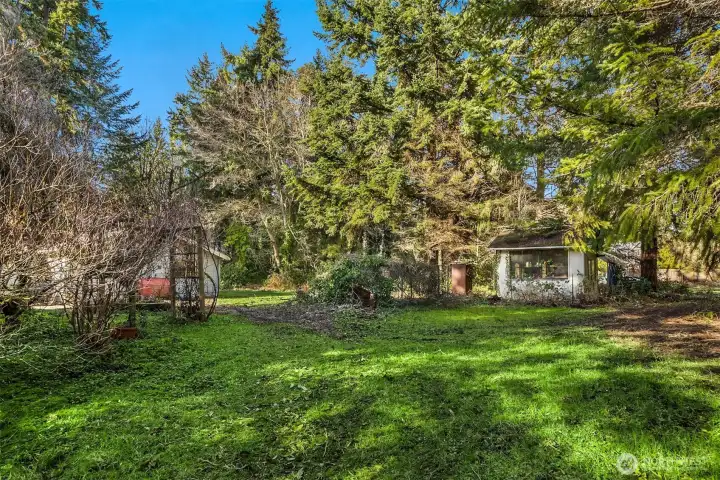 The expansive back yard is flat, usable land with endless potential for gardens, outdoor living, or possible future development.