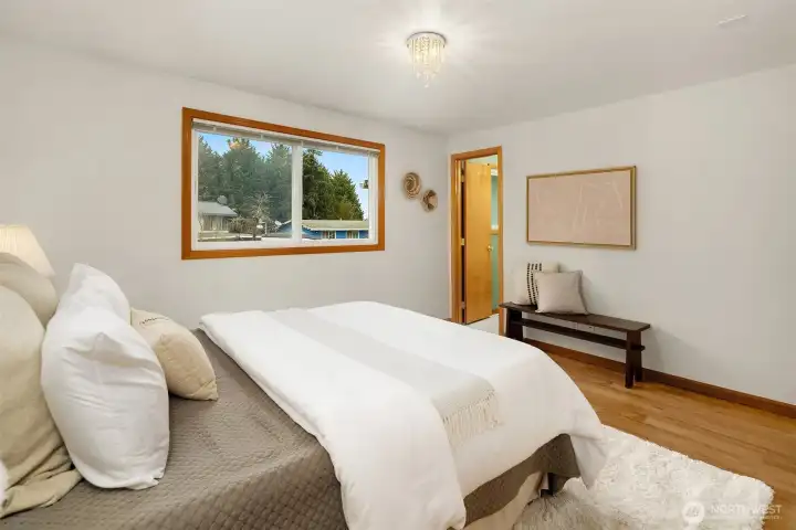 Primary bedroom with view into private bath.