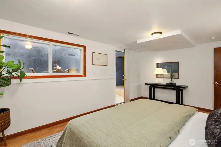 Large downstairs bedroom showing access to shop/fitness/storage room.