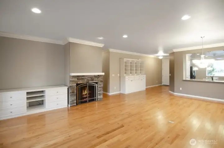 Rock-faced fireplace with white cabinetry offering storage solutions.