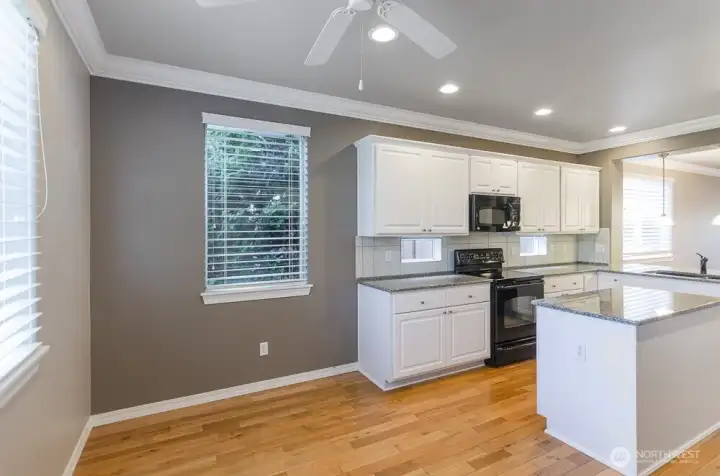 Sunny breakfast nook area can also be used for a sitting area, an office or craft space.