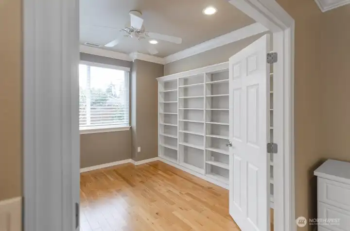 Entry of den off living room showing adjustable shelving. This light and bright room works well as an office, library, or craft room.