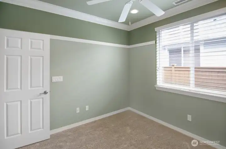 Another view of the second bedroom without furniture.